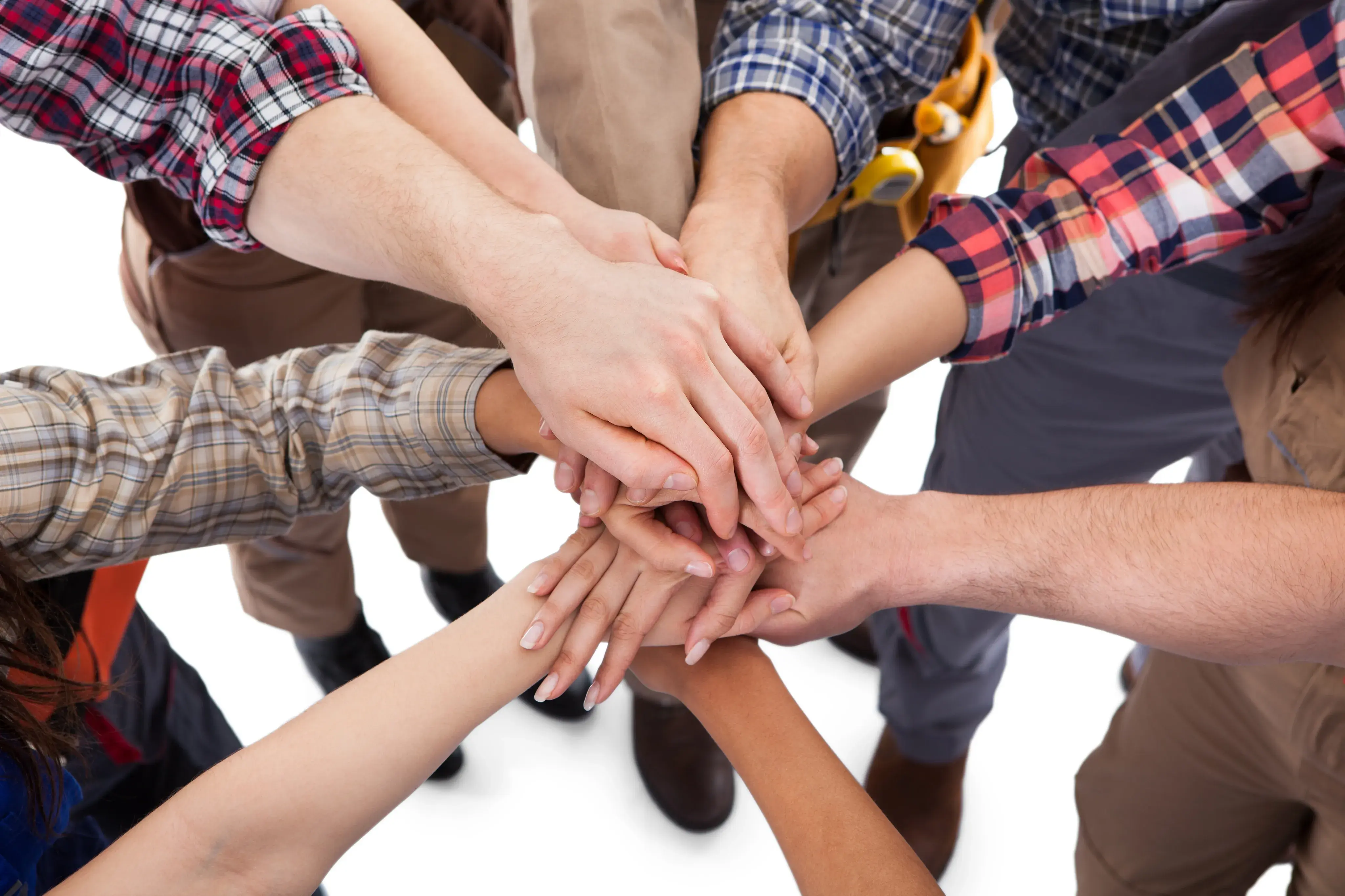 Mehrere Hände liegen übereinander als Zeichen für Teamwork.